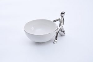 White and SIlver Pampa Bay Snack Bowl with Silver Figure holding the bowl in a seated position