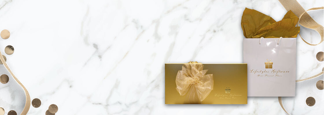 marble background behind two giftwrapped gifts in gold with confetti and ribbons