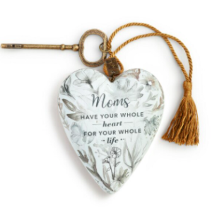 white floral ornamental heart with gold tassel and key